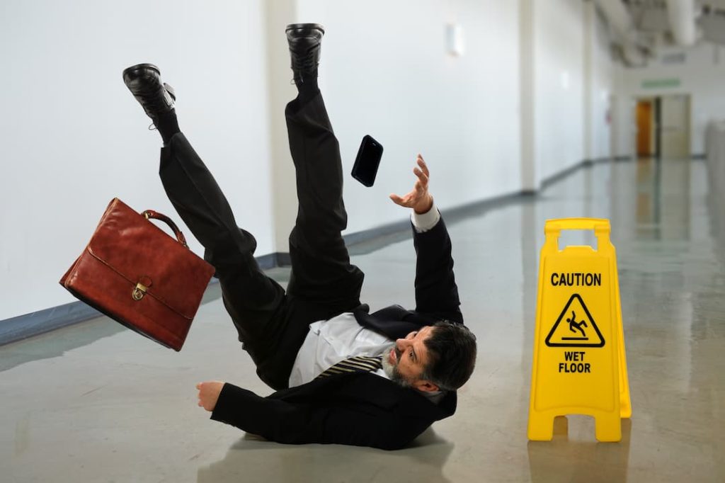 Business Man Falling On A Slippery Floor